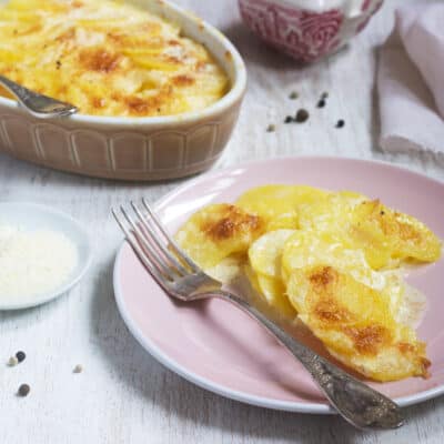 one portion of Low-Carb Celeriac Dauphinoise on a pink plate with a silver fork