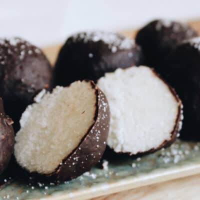 low-carb coco bites on a plate. One of them is cut in half.