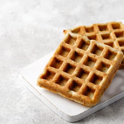 two keto chaffles on a white plate