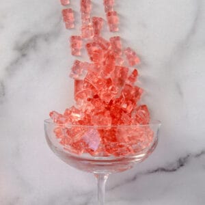 Pink Low-Carb and Keto Gummies in a champagne glass