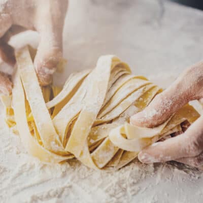 Chef making low-carb pasta, image showing hands, flour and pasta