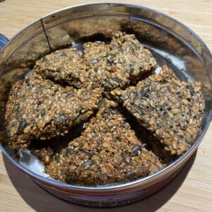 low-carb seeded crackers in a tin