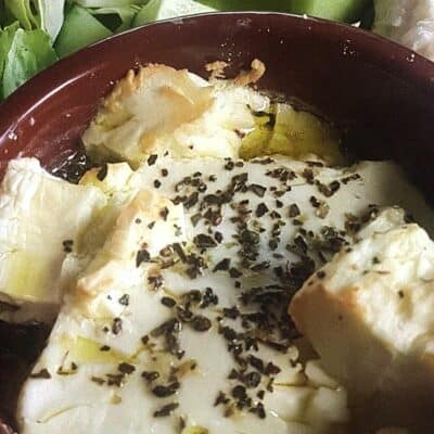 baked feta in a brown bowl